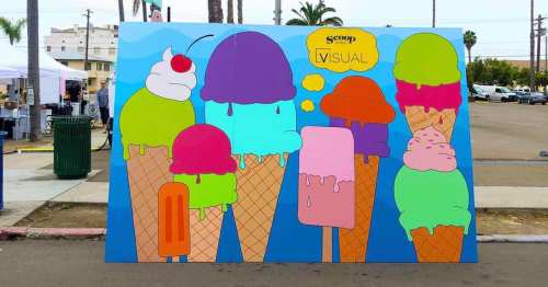 Colorful mural of oversized ice cream cones with various flavors and toppings, set against a bright blue background.