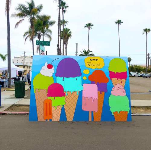 Colorful mural of oversized ice cream cones and popsicles against a palm tree backdrop, promoting a fun, vibrant atmosphere.