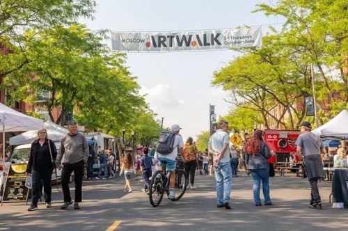 A lively street scene at the Moscow Art Walk, featuring vendors, food trucks, and people enjoying the event.