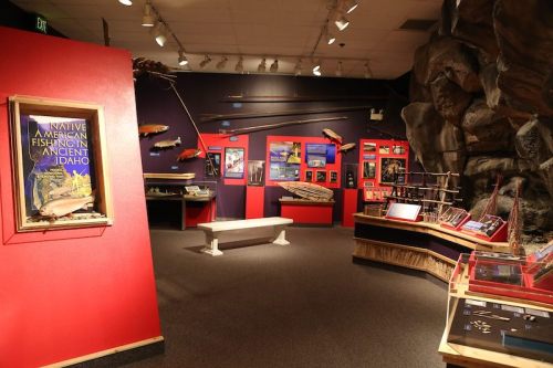 Exhibit showcasing Native American fishing artifacts and information in a museum setting.