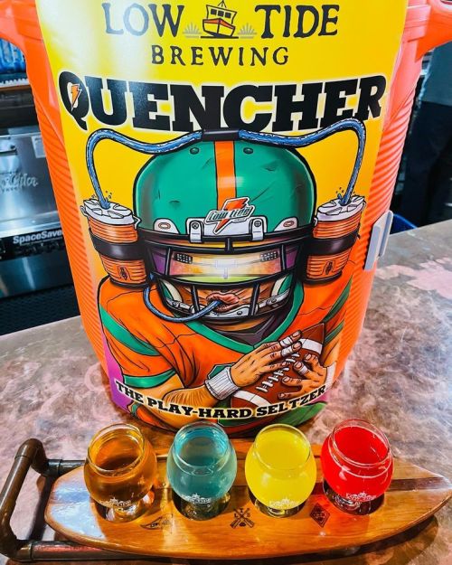 A colorful bucket labeled "Quencher" with a football-themed design, alongside four shot glasses in vibrant colors.
