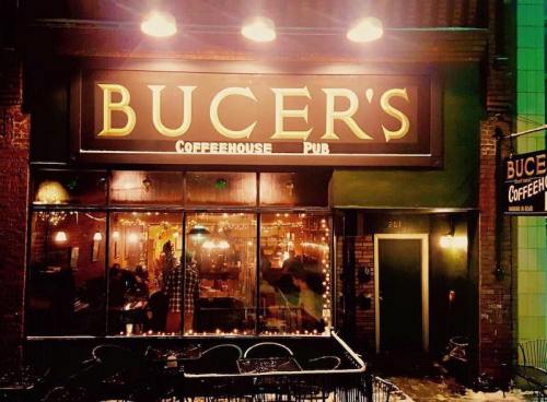A cozy coffeehouse pub with warm lighting and outdoor seating, featuring the sign "Bucer's Coffeehouse Pub."