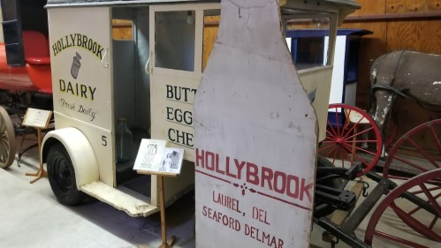 Vintage dairy delivery truck with a large milk bottle sign, labeled "Hollybrook Dairy, Laurel, Delmar."