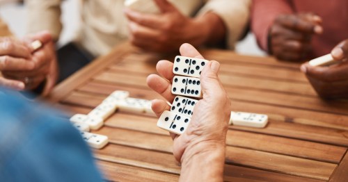 a group playing dominoes at a table