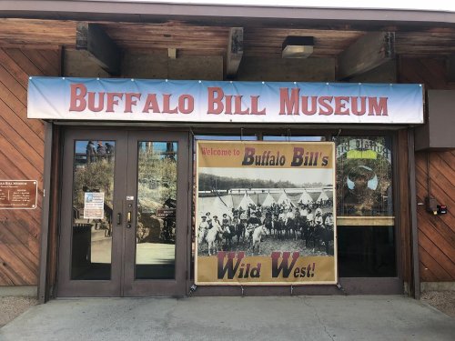 Entrance to the Buffalo Bill Museum, featuring a large banner about Buffalo Bill's Wild West.