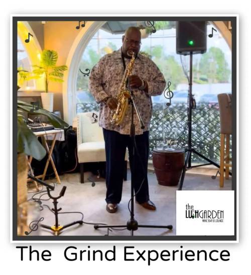 A musician plays the saxophone at The Grind Experience event in a cozy lounge setting.