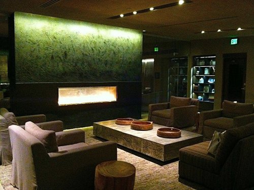 Cozy lounge area with a modern fireplace, comfortable seating, and a stylish coffee table. Warm, inviting atmosphere.
