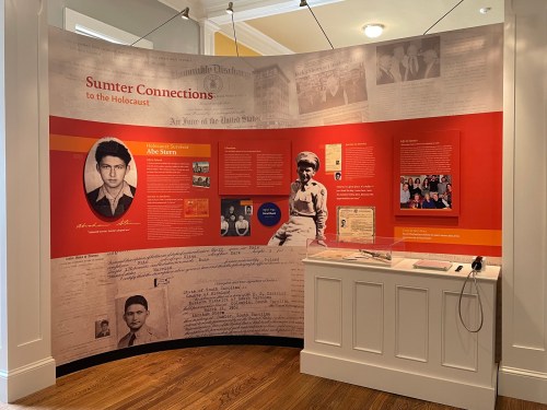Exhibit on Sumter's connections to the Holocaust, featuring photos, documents, and personal stories.