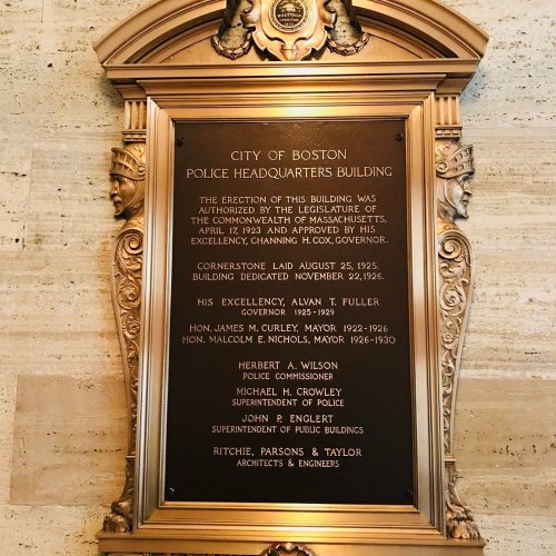 Plaque commemorating the Boston Police Headquarters building, detailing its history and key figures involved.