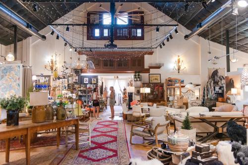 A spacious, stylish interior filled with furniture, decor, and warm lighting, featuring a cozy, inviting atmosphere.