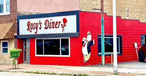 A red diner building with a sign reading "Rosy's Diner" and a mural of a chef holding a plate.