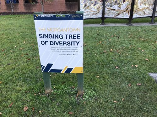 Sign for "The Morgantown Singing Tree of Diversity," highlighting community contributions to the artwork by Debora Palmer.