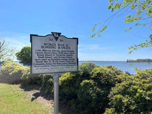 Sign about WWII bombing ranges near Lake Mary, detailing historical use of nearby islands for training missions.