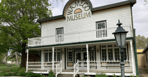 exterior of the wamego historical society and museum housed inside a two-story historic home with a large porch in kansas