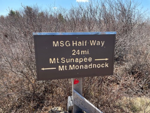 Sign indicating directions to Mt. Sunapee and Mt. Monadnock, with a distance of 24 miles to MSG Half-Way.
