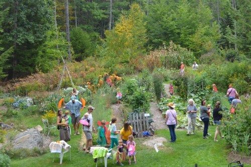 A vibrant garden scene with people of all ages enjoying the outdoors, surrounded by lush greenery and colorful plants.