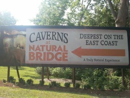 Sign for Caverns at Natural Bridge, highlighting it as the deepest on the East Coast with an arrow pointing left.