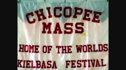Banner reading "Chicopee Mass, Home of the World's Kielbasa Festival" in bold red letters on a white background.