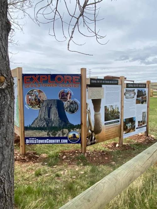 Signage promoting Devils Tower Country, featuring images and information about the area and its attractions.