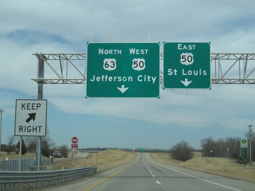 Highway sign indicating directions to Jefferson City (North, West) and St. Louis (East), with a "Keep Right" sign.