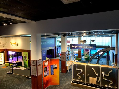 A view of an interactive science exhibit featuring colorful displays and engineering design stations.