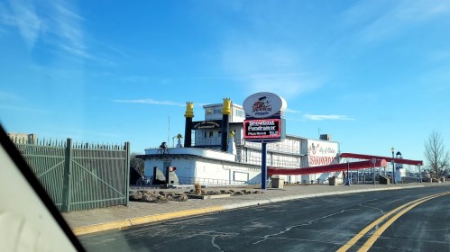 A large, white building with a sign reading "Showboat" and a red awning, set against a clear blue sky.