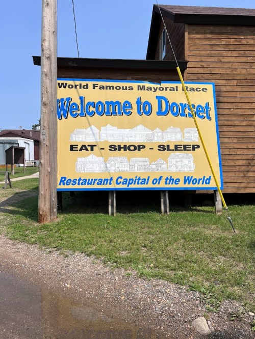 Sign welcoming visitors to Dorset, highlighting it as the "Restaurant Capital of the World" with a playful design.