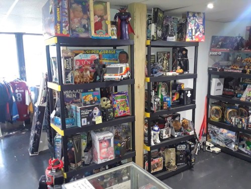A colorful display of shelves filled with various action figures, toys, and collectibles in a store setting.