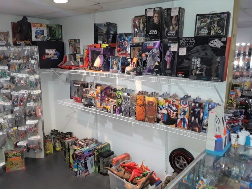 A toy store display featuring shelves filled with action figures, collectibles, and various themed merchandise.