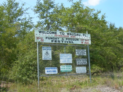 Sign welcoming visitors to Wausau, FL, home of the Funday & Possum Festival, established 1889. Various event details listed.