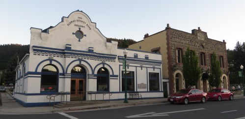 Historic buildings in a small town, featuring distinct architectural styles and a peaceful street scene at dusk.