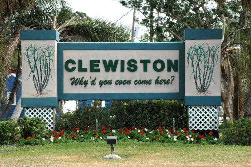 Sign welcoming visitors to Clewiston, featuring the text "Why'd you even come here?" with decorative elements.