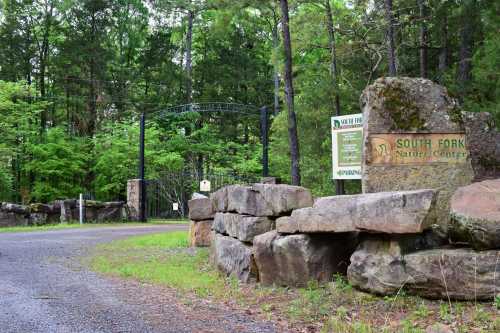 Entrance to South Fork Nature Center, featuring stone signage and lush greenery in the background.