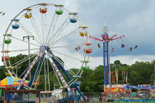 A colorful amusement park scene featuring a Ferris wheel, swing ride, and food stalls under a cloudy sky.