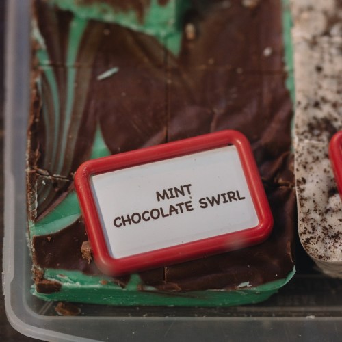 A close-up of a dessert box featuring a mint chocolate swirl treat with a label.