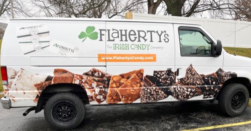 A white van with Flaherty's Irish Candy Company branding and images of various candies on the side.