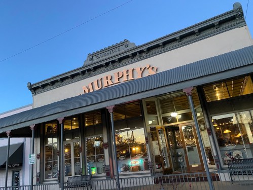 Exterior of Murphy's restaurant with large signage, featuring a vintage-style building and evening sky.