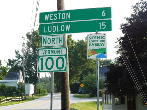 Green road signs indicating distances to Weston (6 miles) and Ludlow (15 miles) on Vermont Route 100 North.