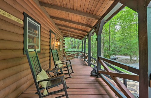 A cozy porch with two rocking chairs, surrounded by trees and a peaceful outdoor setting.
