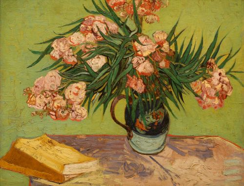 A vibrant still life of pink flowers in a vase on a table, with a yellow book nearby against a green background.