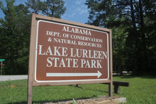 Sign for Lake Lurleen State Park in Alabama, indicating direction and managed by the Department of Conservation.