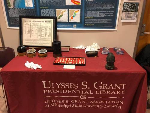 A table displaying artifacts and information at the Ulysses S. Grant Presidential Library event.