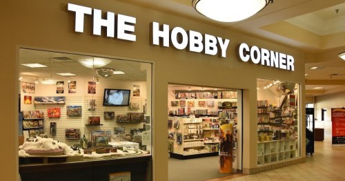 A storefront labeled "The Hobby Corner" featuring shelves of hobby supplies and games inside a shopping mall.