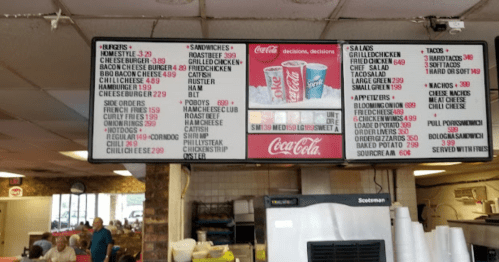 Menu board displaying various food items and prices at a casual dining restaurant.