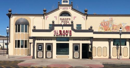 Historic building with a decorative facade, featuring the name "Fargo's" and a mural of a horse-drawn carriage.
