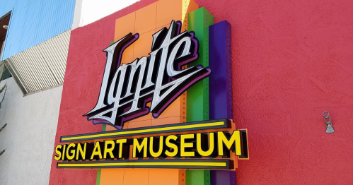 Colorful exterior sign of the Ignite Sign Art Museum, featuring bold lettering and vibrant background.