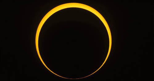 A bright, glowing ring of light against a dark background, depicting a solar eclipse.