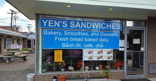 Sign for Yen's Sandwiches featuring bakery, smoothies, and desserts with fresh bread baked daily.