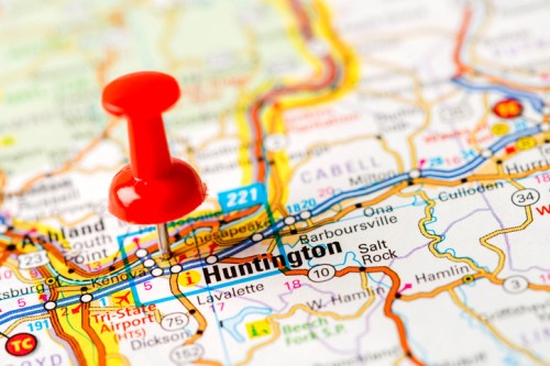 A close-up of a map with a red pushpin marking Huntington, highlighting its location.