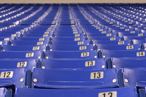 Rows of blue stadium seats with numbered labels, creating a symmetrical pattern.